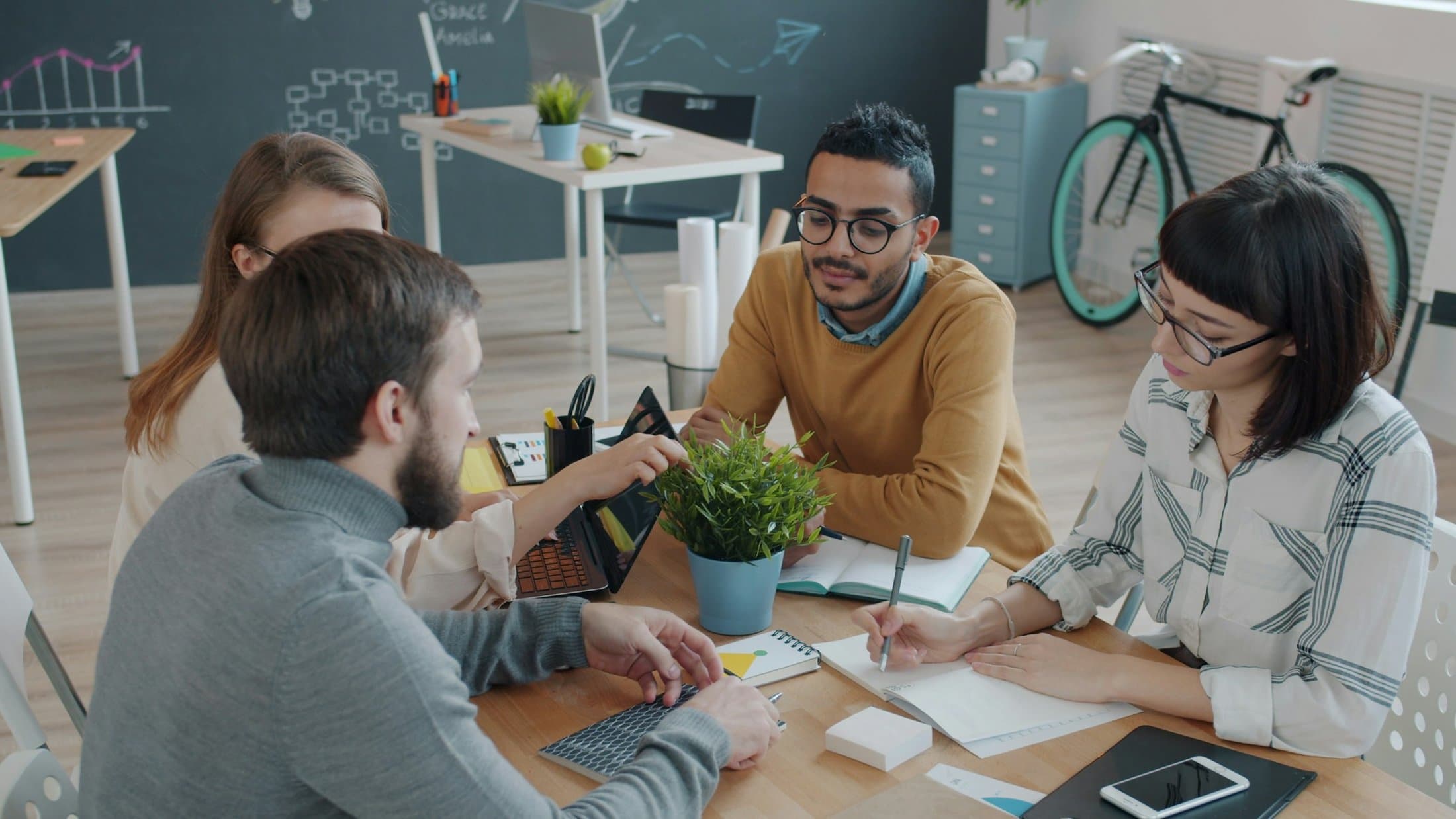 A diverse team of professionals collaborating around a table