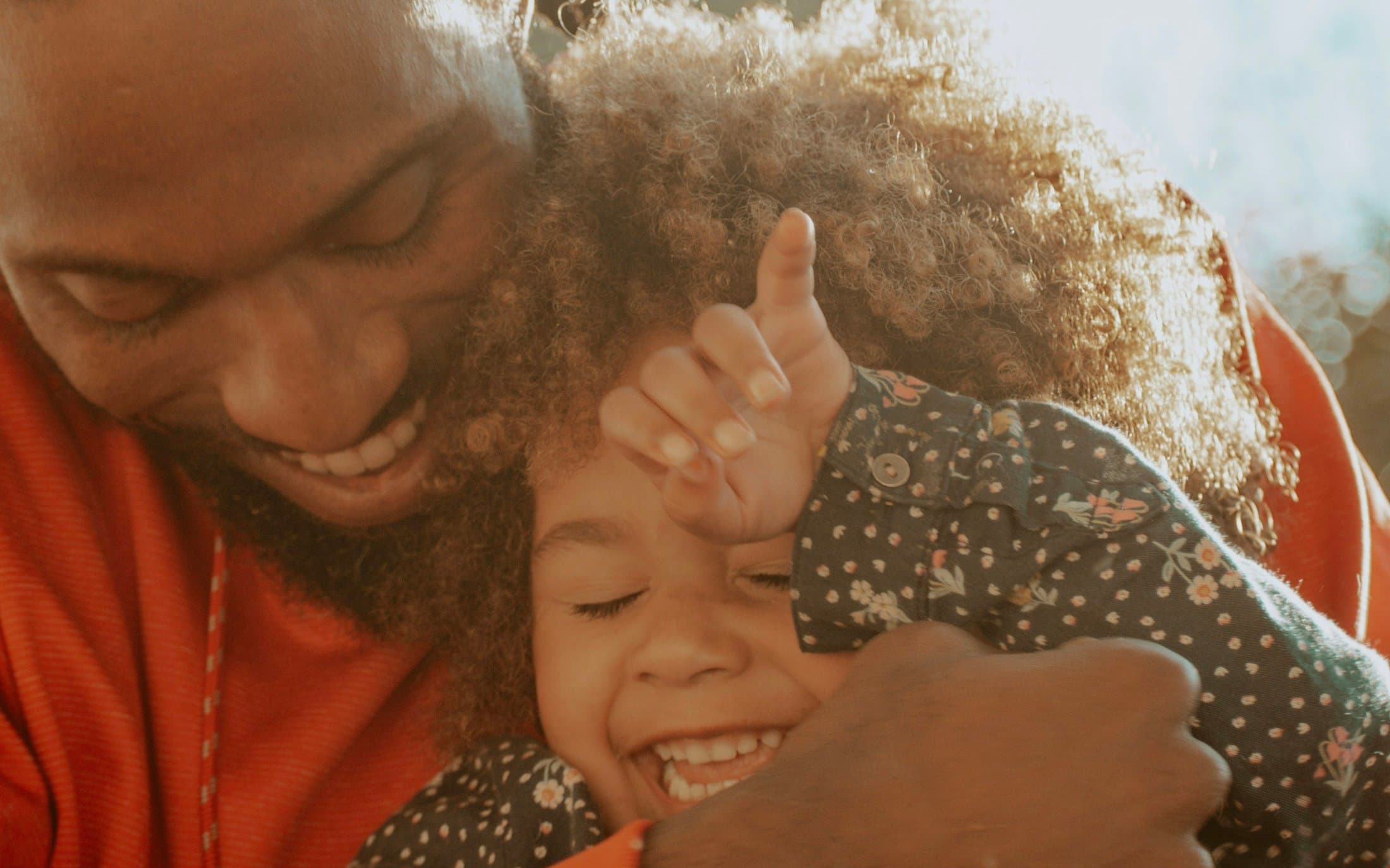 A joyful family together at golden hour, symbolizing a new day of hope